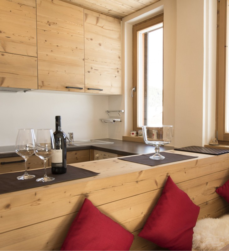 Tanto legno vero, tessuti pregiati e un'atmosfera leggera caratterizzano l'angolo cottura dei nostri chalet.